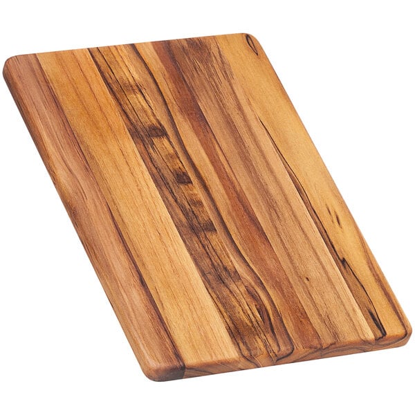 A Teakhaus edge grain teakwood cutting board with a wooden handle.