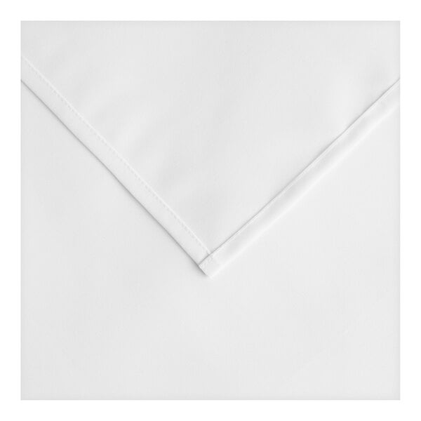 A close-up of a white square cloth with a hemmed edge.