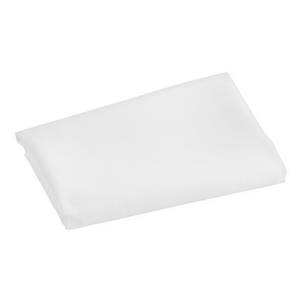 A white folded fabric square on a white surface.