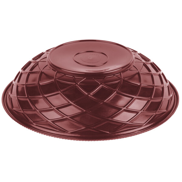 A red plastic lid with a round top on a disc.