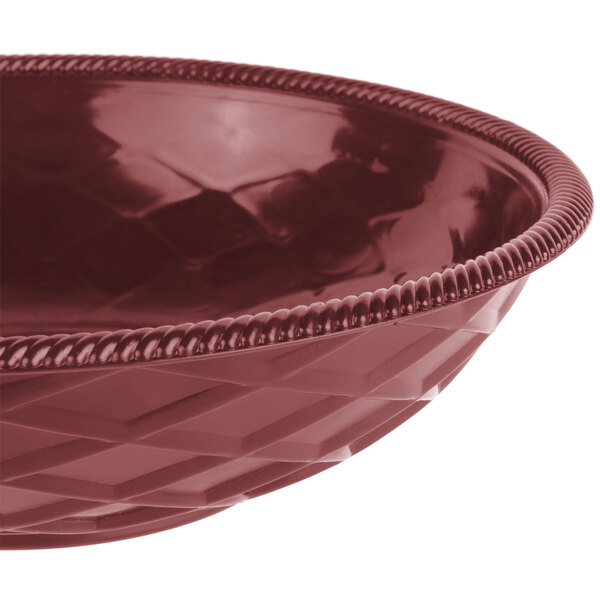 A raspberry polyethylene round weave basket with a handle.