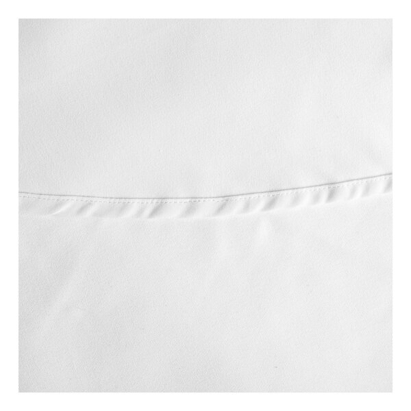 A close-up of a white hemmed cloth table cover.