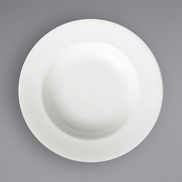 A close-up of a warm white porcelain pasta bowl.