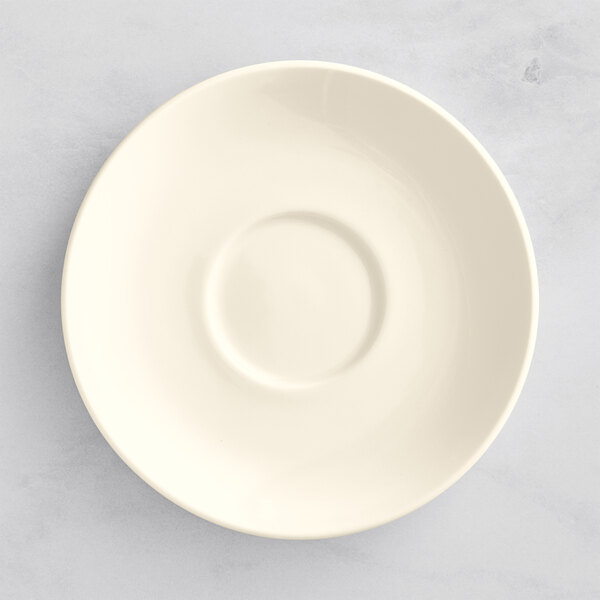 A white porcelain saucer with a circular rim.