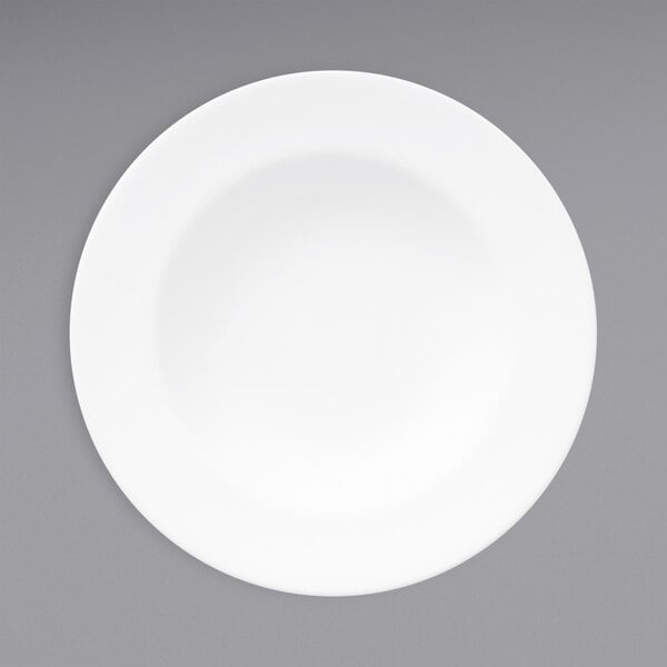 A Oneida warm white porcelain soup bowl with a white rim on a gray surface.