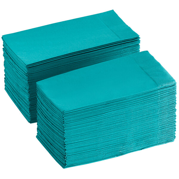 A stack of teal paper napkins.