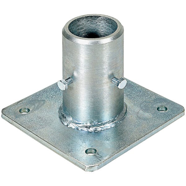 A close-up of a metal plate with a hole in it with screws.