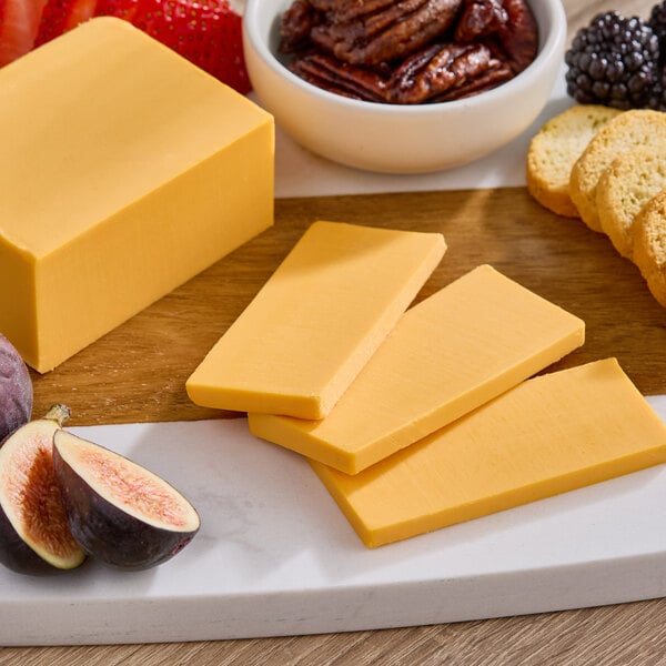 A cheese board with Daiya vegan cheddar cheese, fruit, and crackers.