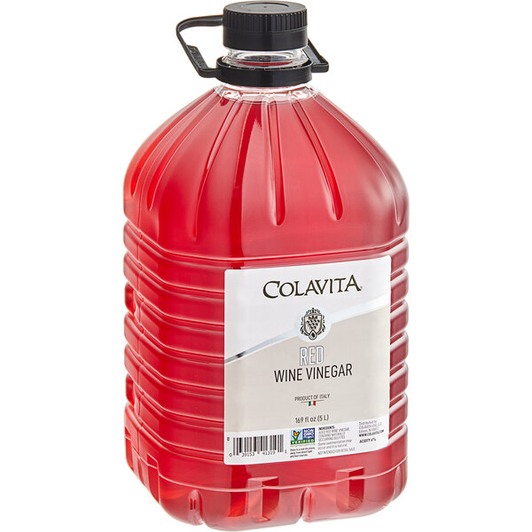 A large bottle of Colavita red wine vinegar with red liquid inside.