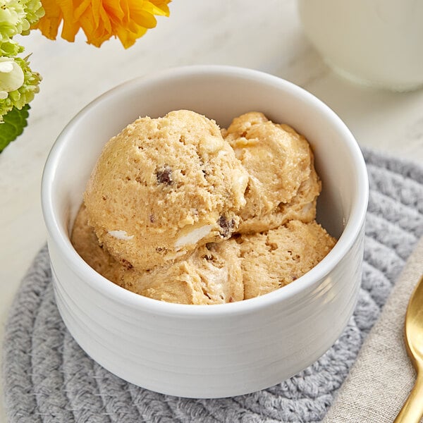 A bowl of Cookie Dough Bliss Smores cookie dough with a spoon in it.