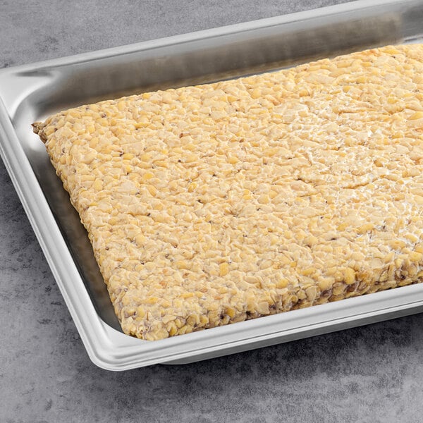 A rectangular piece of Lightlife Original Tempeh in a metal tray.