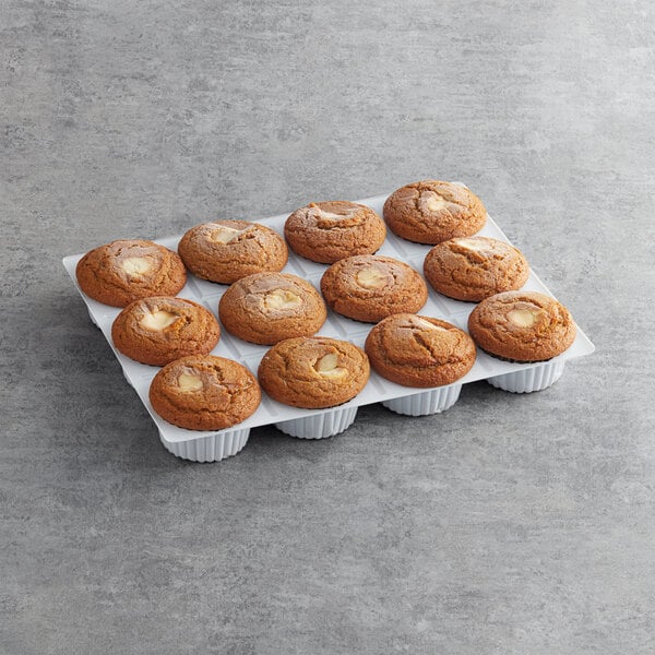 A tray of David's Cookies Pumpkin Cream Cheese Muffins on a gray surface.