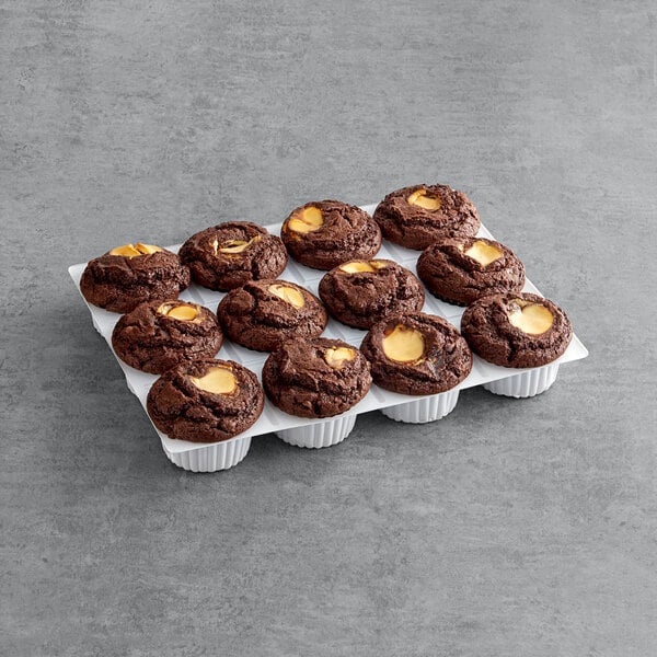 A tray of David's Cookies chocolate cream cheese muffins on a counter in a bakery display.
