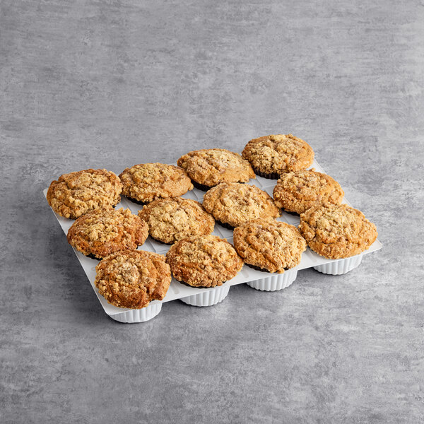 A tray of David's Cookies Cinnamon Chip Muffins on a gray surface.
