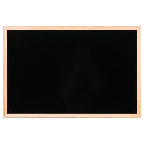 An oak-framed black marker board.