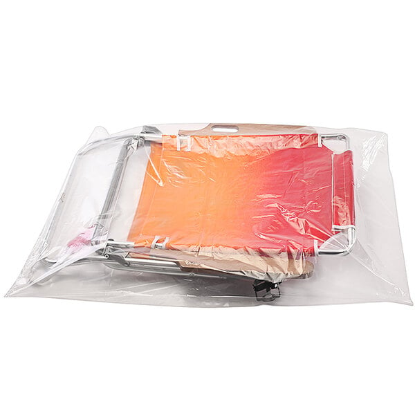 A clear plastic Lavex poly bag with a red and orange seat inside.