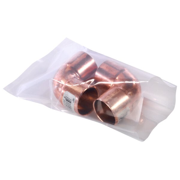 A clear plastic bag with two copper pipes inside.