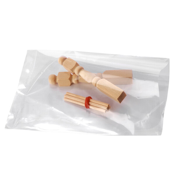 A bunch of Lavex clear plastic bags filled with wooden toy pieces.