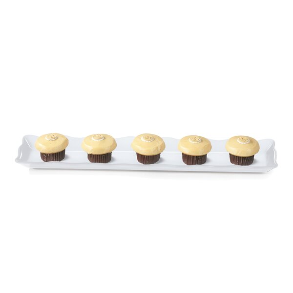 A GET white melamine rectangular display tray with four cupcakes on it.