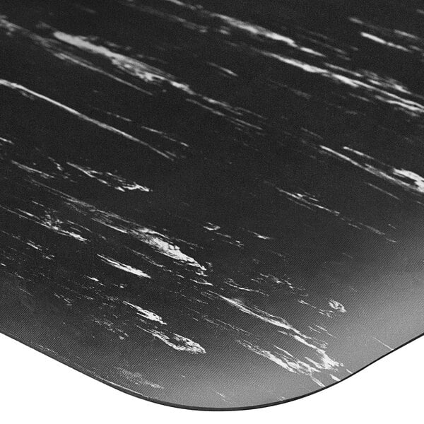 A black surface with white marble patterns on a Lavex K-Marble Foot anti-fatigue mat.