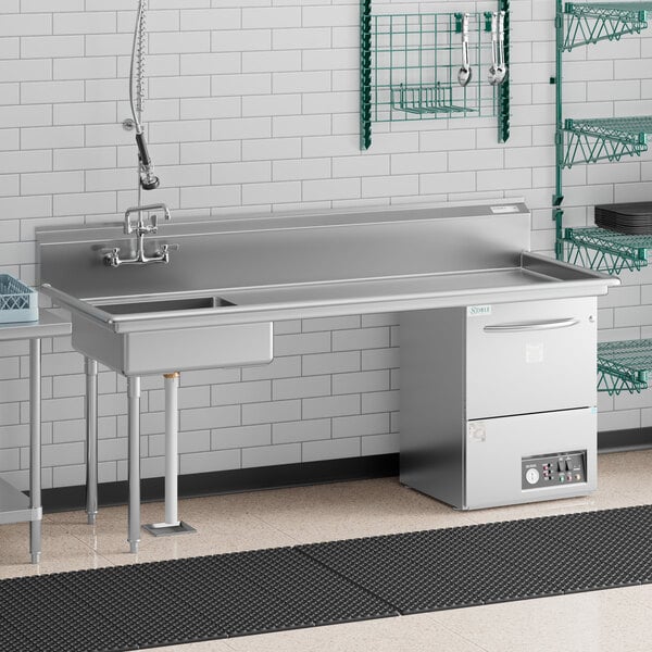 A Regency stainless steel dishtable with a right drainboard under a counter with a sink and dishwasher.