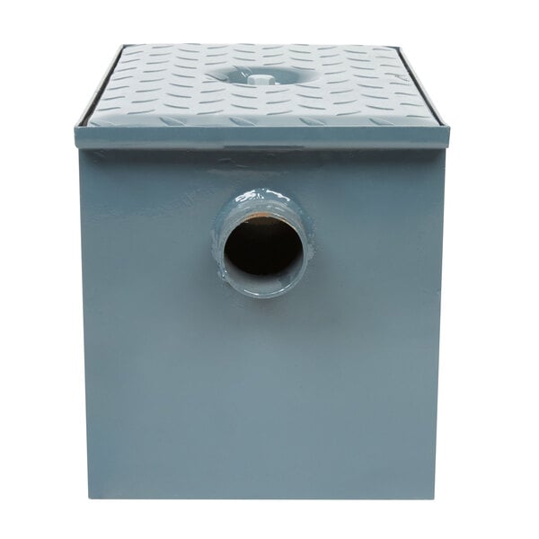 A grey rectangular Watts WD-4 grease trap with a hole in the bottom.