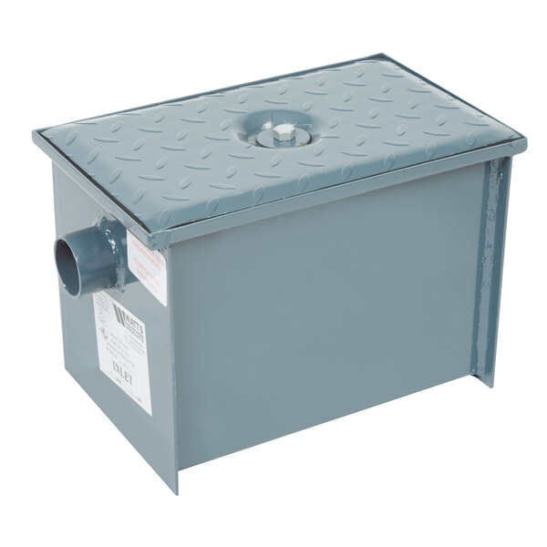 A grey metal Watts WD-4 grease trap box with a hole on top.