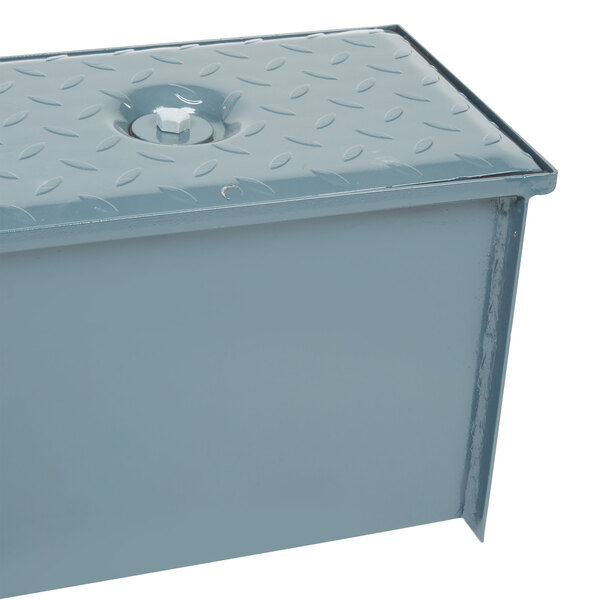 A grey metal Watts WD-4 grease trap box with a hole in the middle.