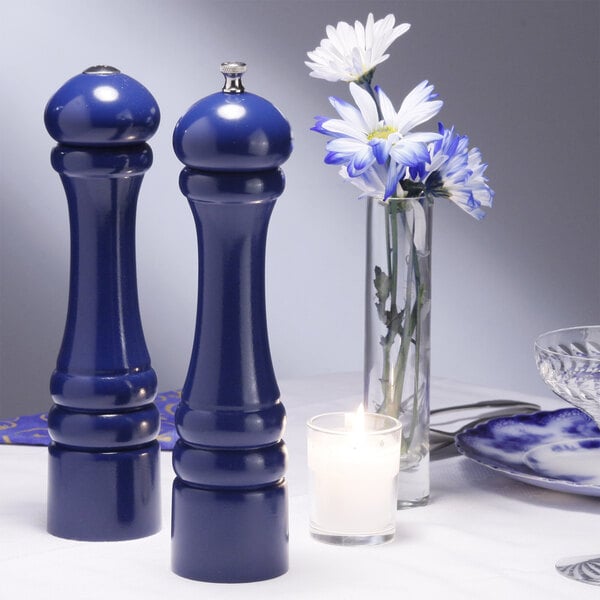 Two cobalt blue salt and pepper shakers on a table.