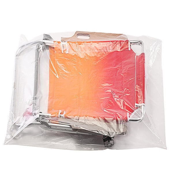 A clear plastic Lavex poly bag with orange and red items inside.