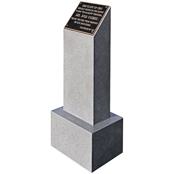 A stone monument bollard with a plaque on it.