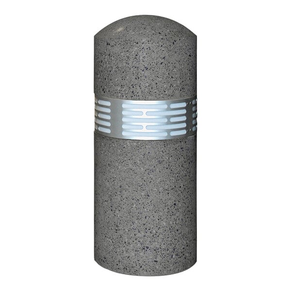 A close-up of a grey concrete cylinder with a silver band.