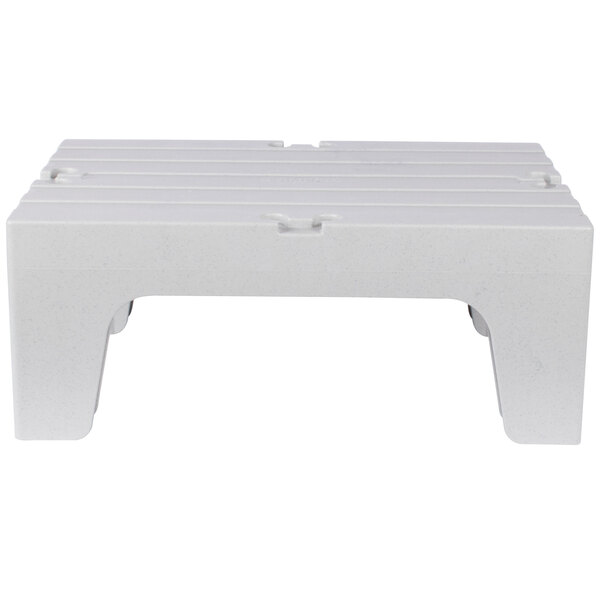 A white plastic bench with legs.