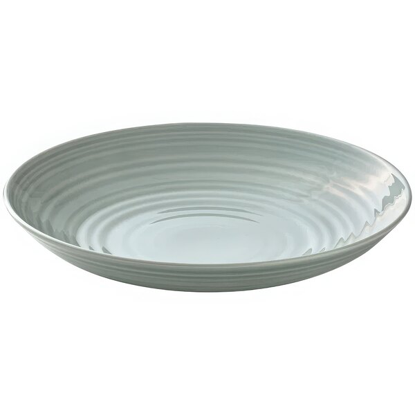 A white porcelain deep coupe plate with a curved edge and a ripple pattern.