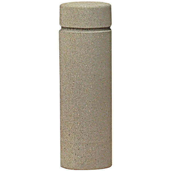 A close-up of a cylindrical concrete bollard with a reveal line.
