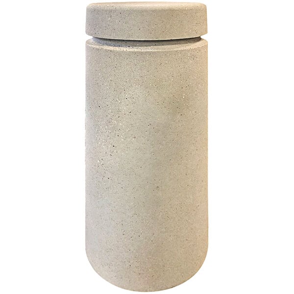 A close-up of a white cylindrical Wausau Tile bollard with a reveal line.