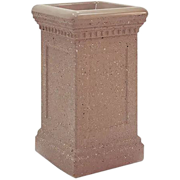 A Wausau Tile Cartier square concrete ash receptacle with a decorative design on a table outdoors.