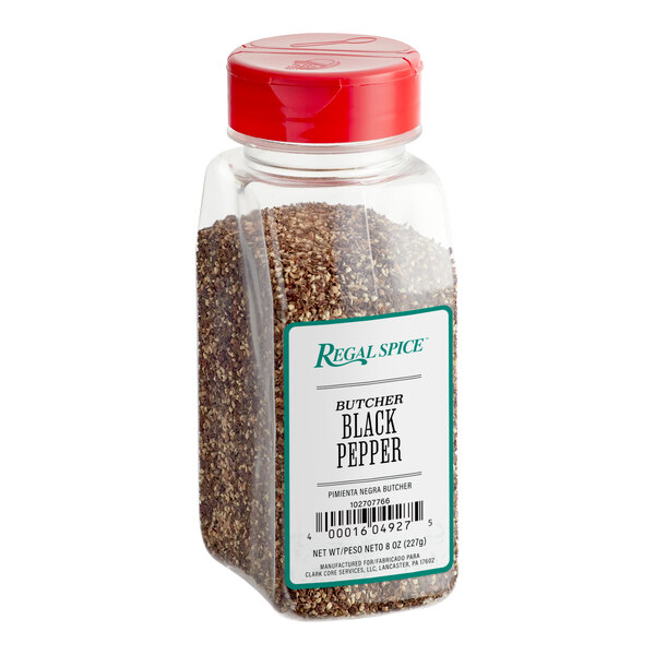 A plastic container of Regal Butcher Grind Black Pepper with a red lid.