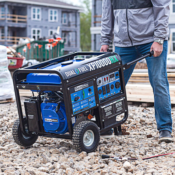 A man pushing a DuroMax portable generator.