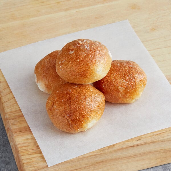 A group of Poppy's plain bagel holes on a cutting board.