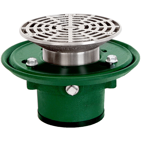 A green and silver Josam round floor drain with a circular metal grate.