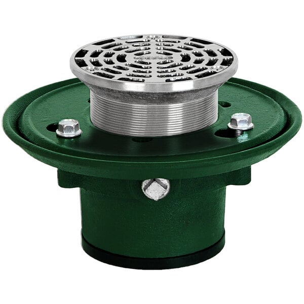 A Josam round cast iron floor drain with a green and silver Nikaloy strainer.