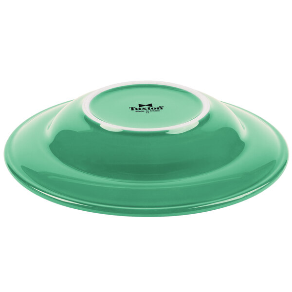 A green bowl with a white rim.