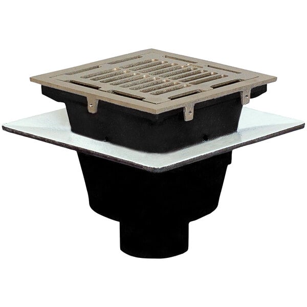 A Josam square cast iron floor sink with a metal grate over the drain.