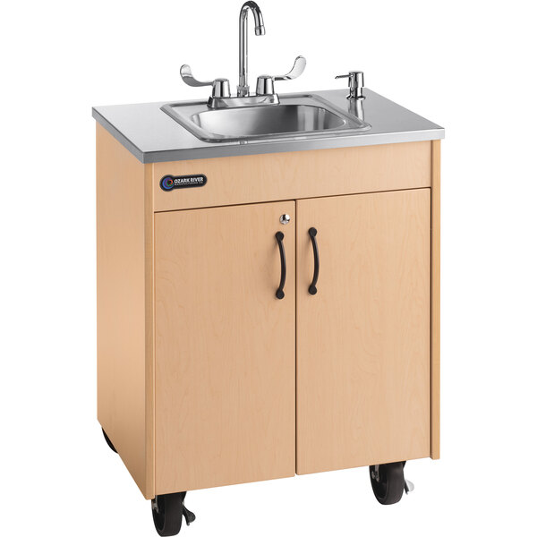 An Ozark River Manufacturing portable hot water hand sink with a stainless steel basin on a laminate counter.