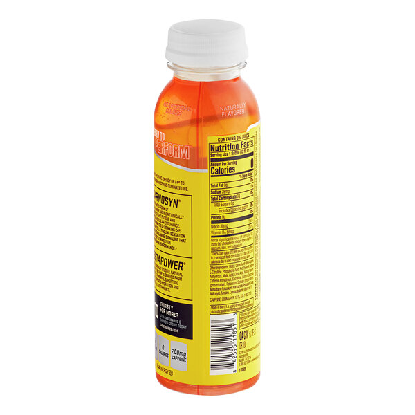 A close-up of a yellow C4 Energy bottle with orange liquid inside.