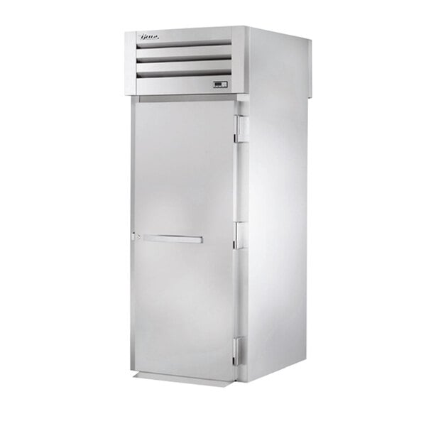 A white True roll-through heated holding cabinet with a stainless steel door.