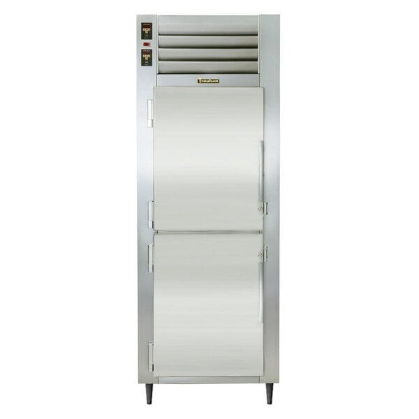 A Traulsen white refrigerator with two white doors and a metal frame.