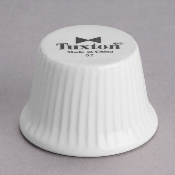 A white fluted ceramic Tuxton ramekin.