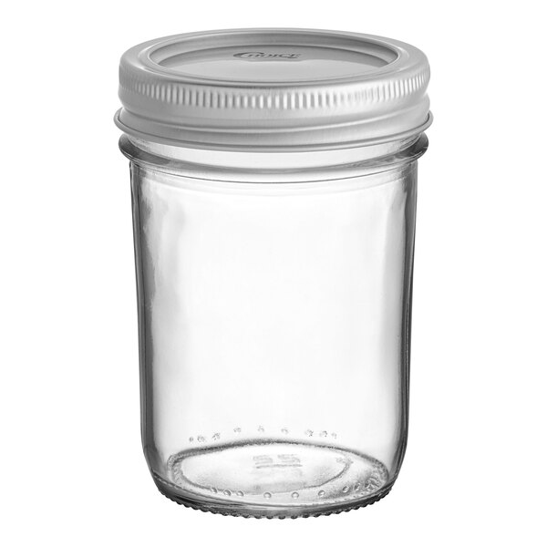 A clear glass Choice half-pint canning jar with a white metal lid.